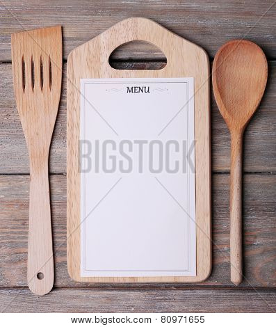 Cutting board with Menu sheet of paper on rustic wooden surface background