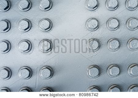 Gray Painted Metal Surface With Hexagonal Bolt Heads