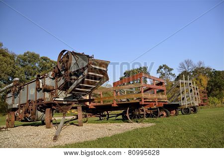 Threshing machine and racks for hauling bundles