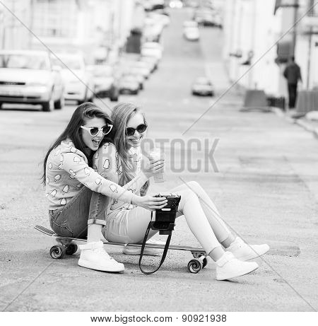 Hipster girlfriends taking a selfie in urban city context - Concept of friendship and fun with new t
