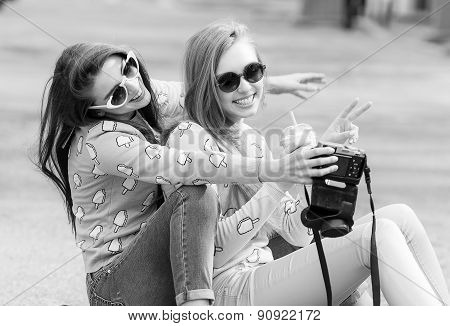 Hipster girlfriends taking a selfie in urban city context - Concept of friendship and fun with new t