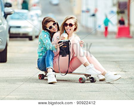 Hipster girlfriends taking a selfie in urban city context - Concept of friendship and fun with new t