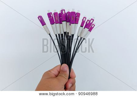 A group head connector fiber optic blue color in hand on white background.Fiber Optics connectors.