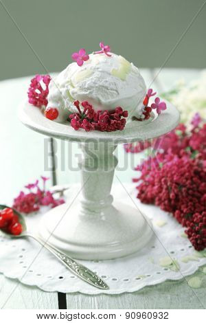 Beautiful composition with tasty ice cream and lilac flowers