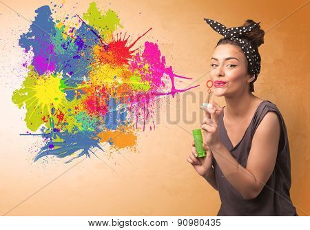 Cute girl blowing bubble spalsh graffiti into wall
