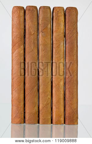 Different Cigars On A  Glass Desk