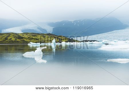 Icebergs In The Glacial Lake With Mountain Views.