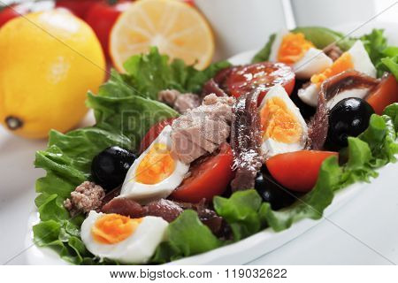 Salad Nicoise with tuna, anchovy, boiled eggs, olives and lettuce