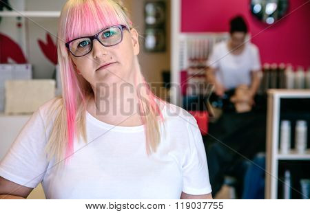 Woman hairdresser standing in hair and beauty salon