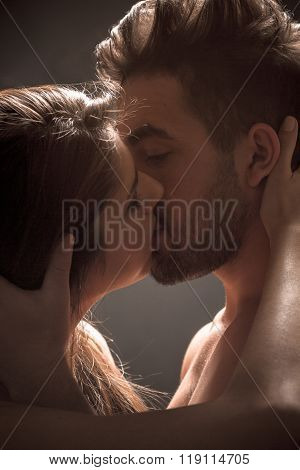 Sexy couple kissing in studio