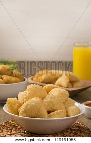 Pastel, A Brazilian Snack, With A Bar In The Background. Cheese Pastry.