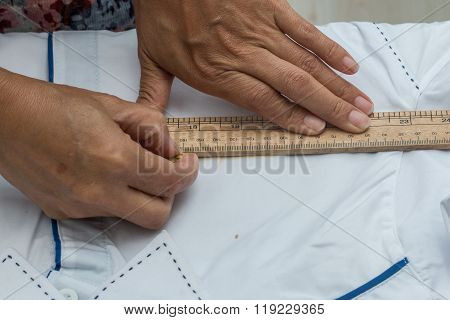 A hand of marking a uniform , Marking, A tailor is laying out a dress/Sewing layout