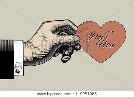 Vintage engraving drawing of hand holding a red heart with I love You lettering. Retro style valentine greeting card design. Vector illustration