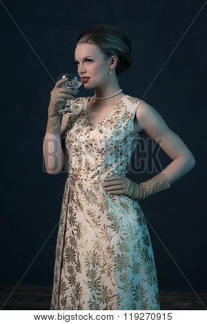 Chique Vintage 50S Fashion Woman In Gold Dress Holding Champagne Glass.