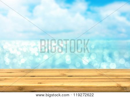 Empty Wood Table Top For Product Disply With Blur Blue Ocean And Sea View Bokeh Light