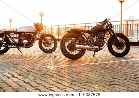 Two Black And Silver Vintage Custom Motorcycles Caferacers