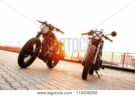 Two Black And Silver Vintage Custom Motorcycles Caferacers
