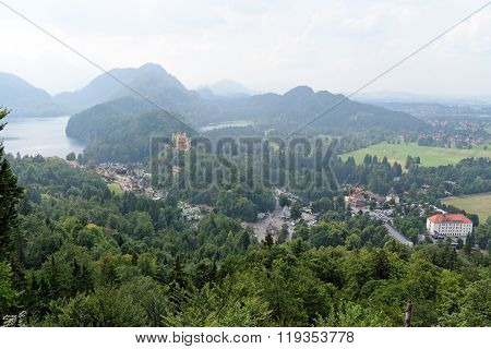 View of Hohenschwangau Castle in a summer foggy day near the lake Alpsee in Bavaria Germany.
