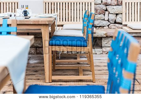 Wooden chairs and wooden tables in summer tarrace of restaurant