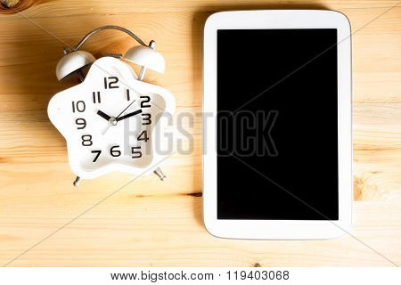 Education Concept. Top View Alarm Clock On Wood Table With Tablet Pc, Vintage Tone