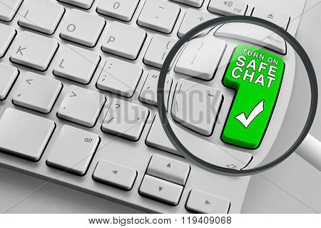 Computer keyboard with green safe chat button and magnifying glass