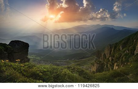 Panorama. Carpathian Mountains. View from Mount Pop Ivan. The rays of the setting sun.