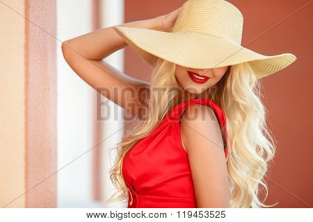 Beautiful woman in straw hat with large brim