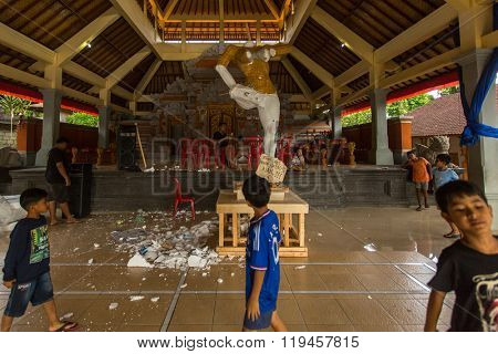 BALI, INDONESIA - FEB 25, 2016: Unidentified local child during built Ogoh-ogoh are statues for the Ngrupuk parade, which takes place on the eve of Nyepi day. Nyepi is a public holiday in Indonesia.