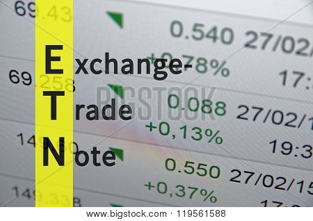 Acronym ETN as Exchange-traded note. Financial data on the background.