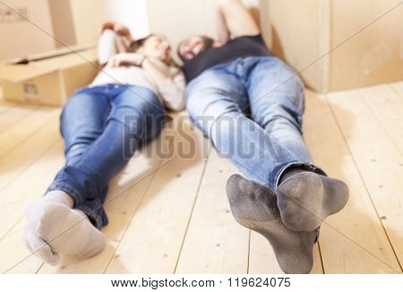 young couple relaxing after moving at home