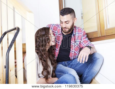 young couple moves into new home relaxing
