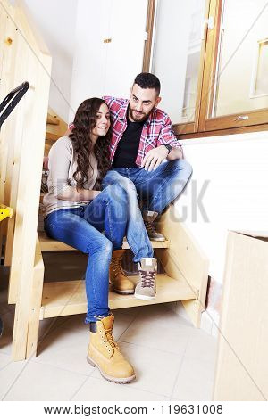 young couple moves into new home relaxing