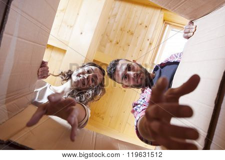 Young Couple Opened The Boxes. View From Inside The Box