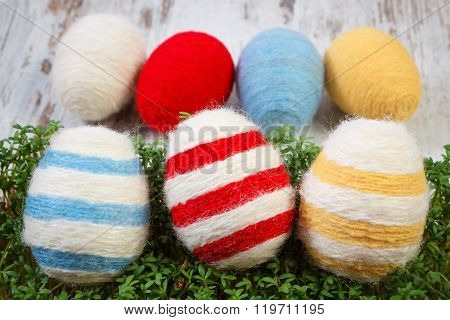 Easter Eggs Wrapped Woolen String And Green Cress On Wooden Background, Decoration For Easter