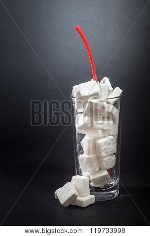 Glass Full Of Sugar Cubes With Straw