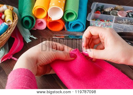Closeup Of Woman Hands Sewing Pink Hamdmade Toy