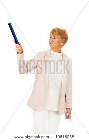 Smile elderly woman pointing up with hege pen