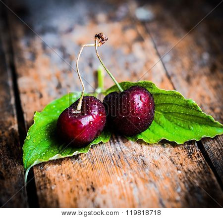 Cherries On Rustic Wooden Background