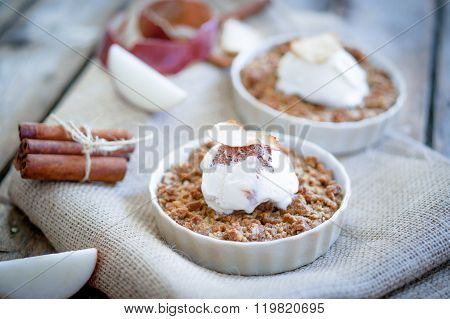 Apple Crumble Dessert With Cinnamon And Vanilla Ice Cream On Wooden Background