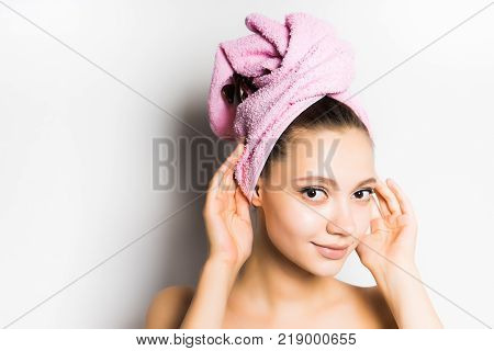 girl with a pink towel on her head smiling