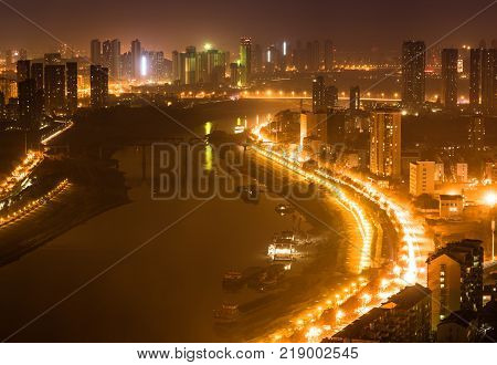 Aerial night view cityscape of Han river between Hankou and Hanyang districts in Wuhan central China
