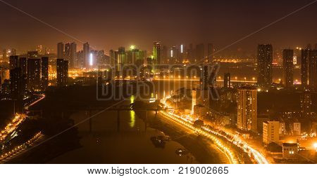 Aerial night view panorama of Han river between Hankou and Hanyang districts in Wuhan central China
