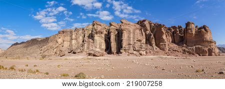 Panoramic view on unique stone formation - pillars of the Solomon King in Timna geological park that is located 25 km north of Eilat (Israel), combines beautiful scenery with unique geology, variety of sport and family activities
