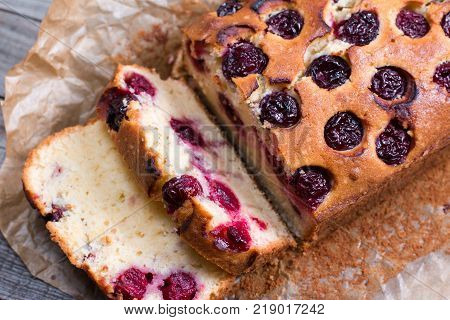 Cherry sponge cake on a wooden background