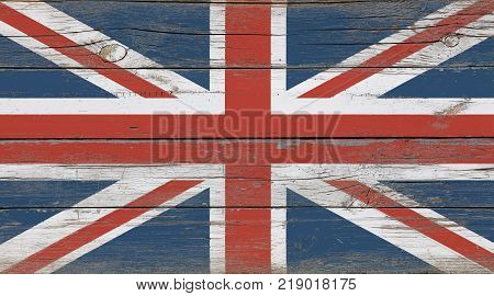 Old vintage UK British flag over white wood