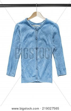 Blue knitted cardigan on wooden clothes rack isolated over white