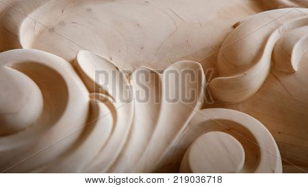 wood carving. the carving element. close up. small depth of field. toning effect. use as background