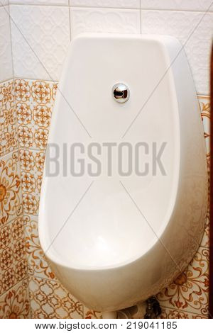 White ceramic pissoir in a classic wc