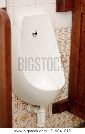 White ceramic pissoir in a classic wc