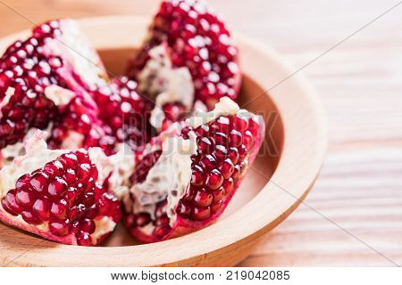 Big red pomegranate on the wooden board. Ripe granet fruit.